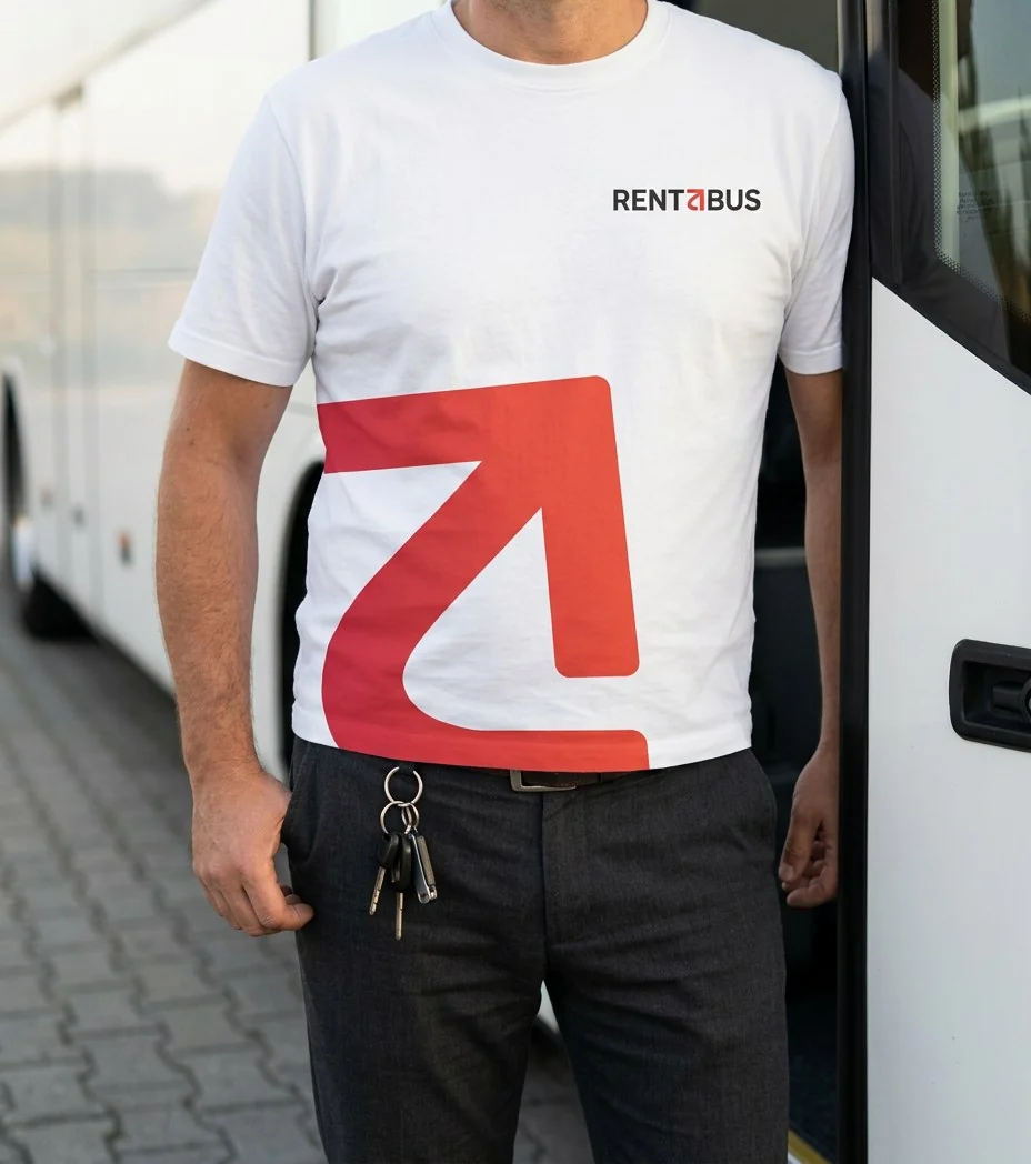Concept mockup: a driver in a white T-shirt with the red mark printed large across the front and the Rentabus logo on the chest, standing next to a coach