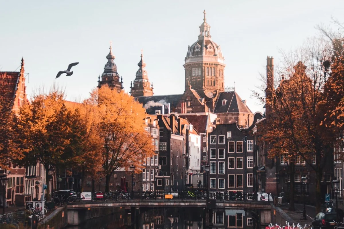 Canal houses and a church in Amsterdam in autumn