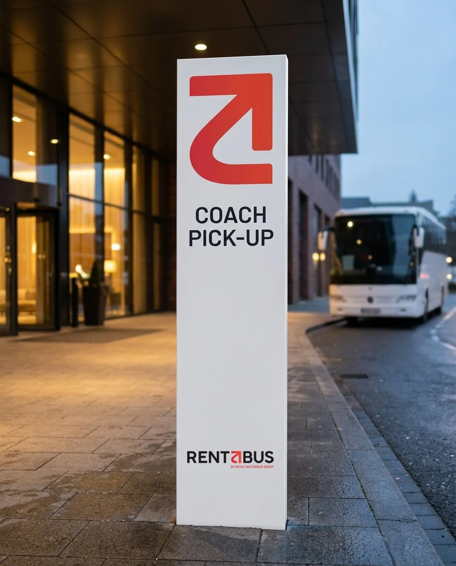 Concept mockup: a white sign outside a hotel entrance with the red mark, the words Coach pick-up and the Rentabus logo, and a coach waiting at the kerb