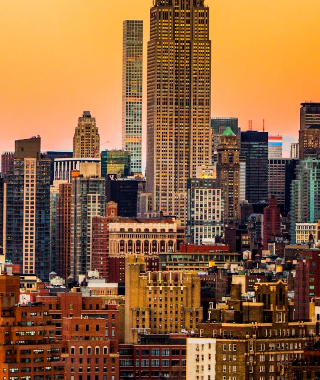 A letter a filled with the New York skyline at sunset. The Empire State Building rises out of the top.