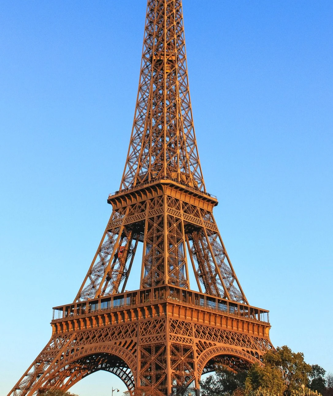 A letter a filled with blue sky. The Eiffel Tower rises out of the top of the letter.