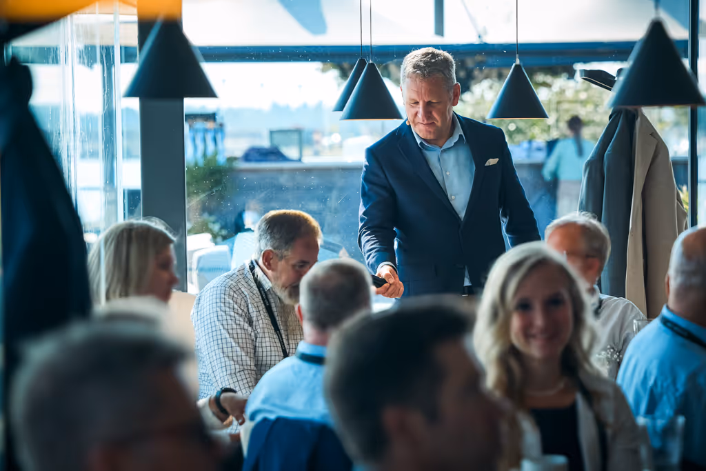 Jaakko Interviewing a male in a room full of people