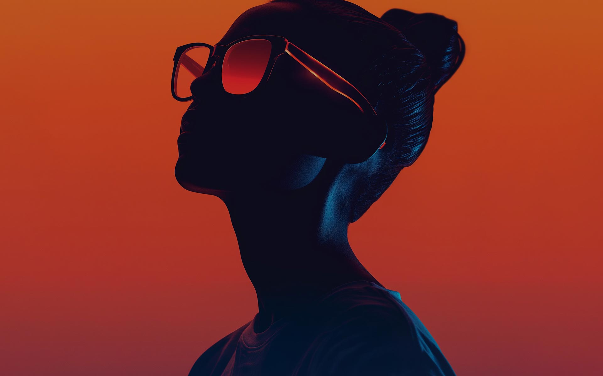 Beautiful young woman in orange glasses on orange background.