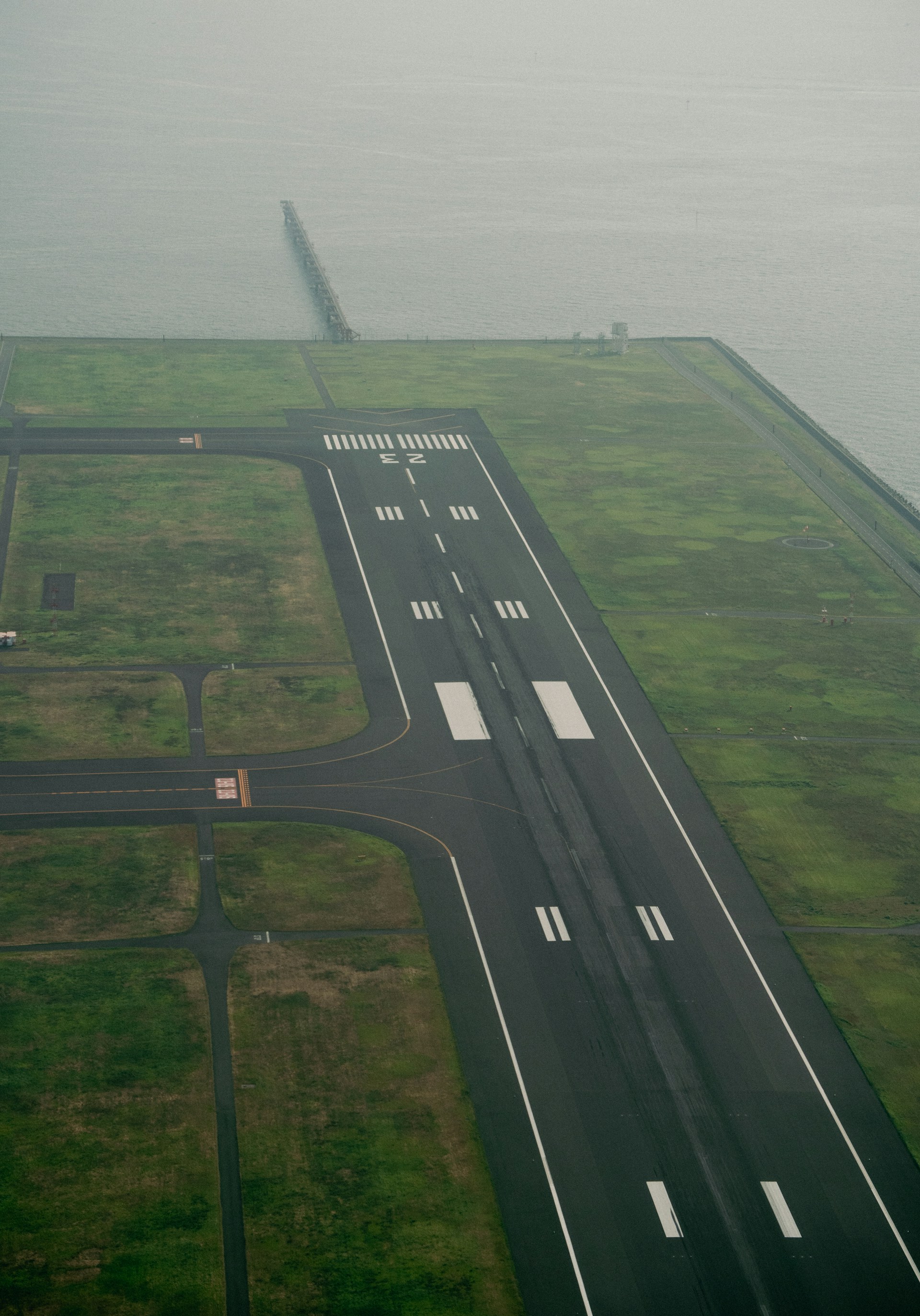 Foggy scene of a runway near the coastline