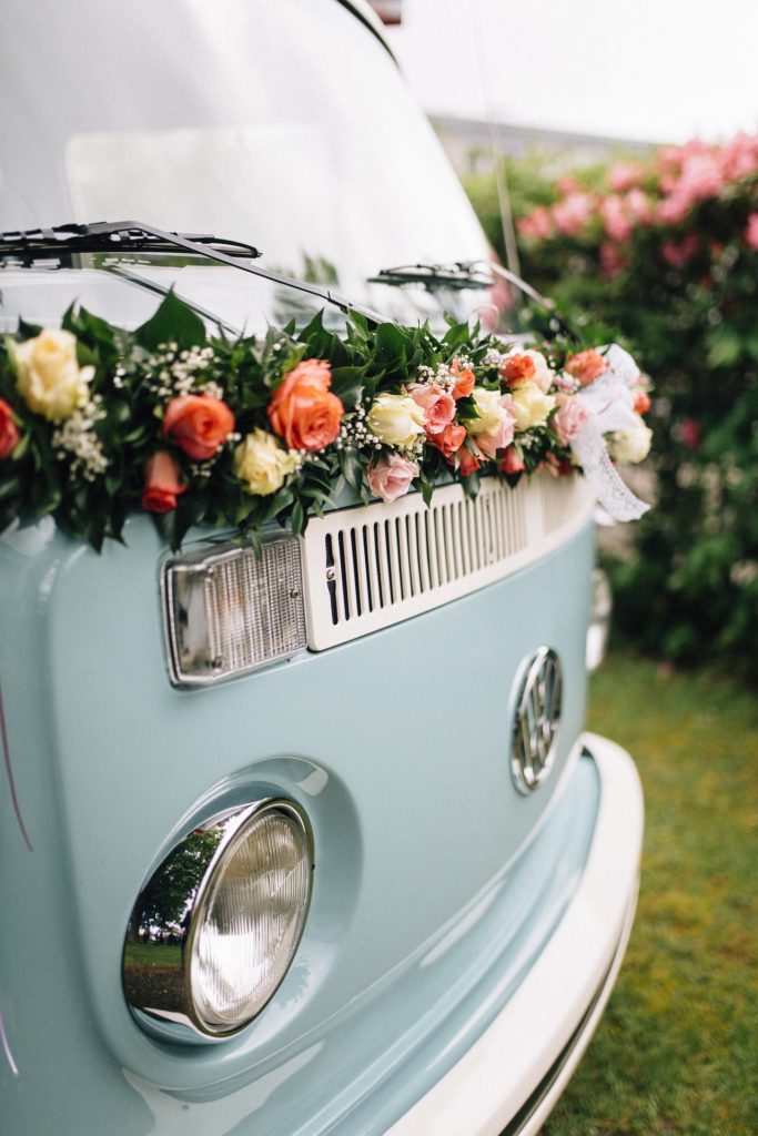 Blue vintage wedding van covered in florals