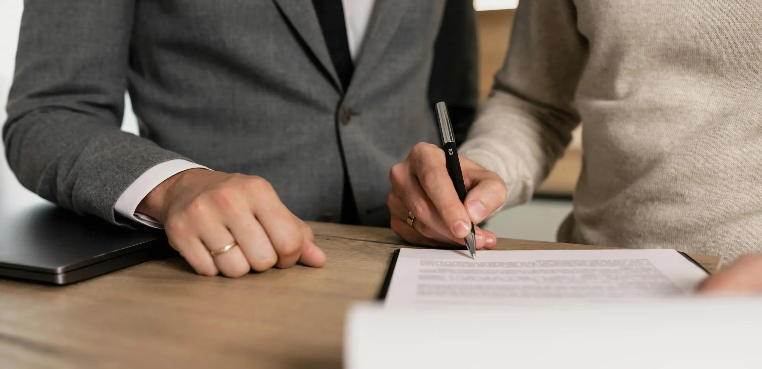 Two people negotiating and signing a contract