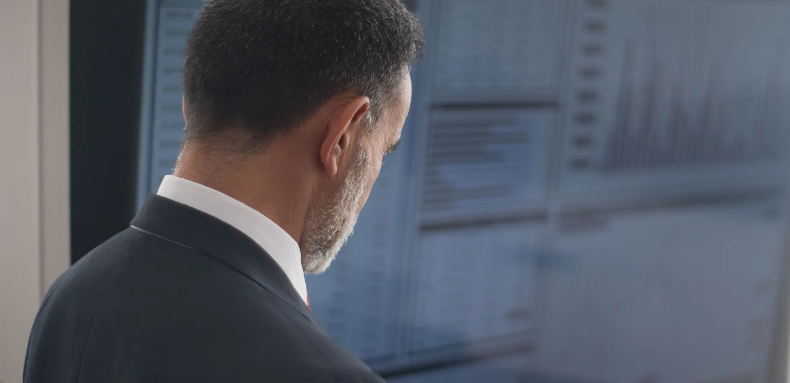 Man in suit in front of screen