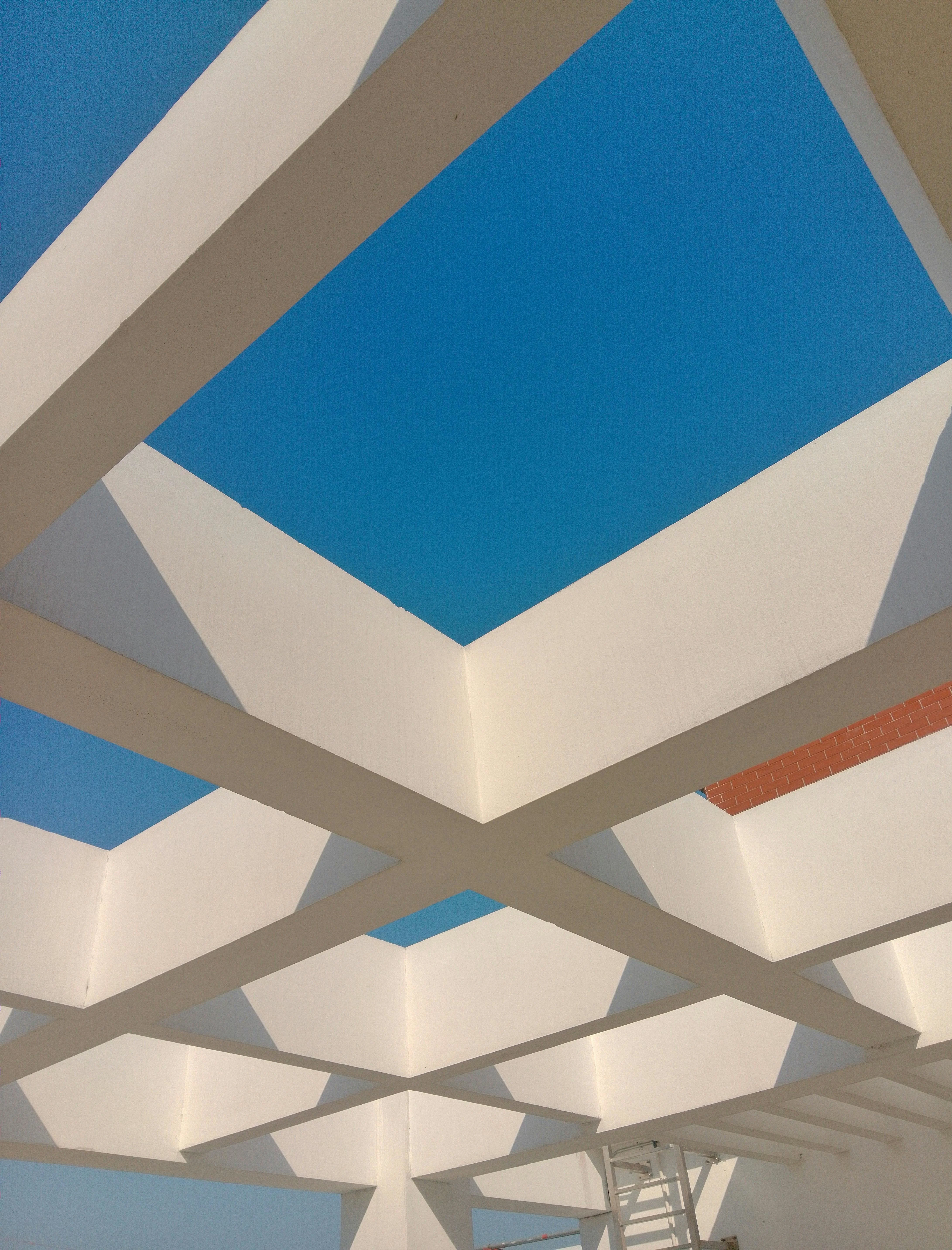 A wooden roof with blue sky in the background