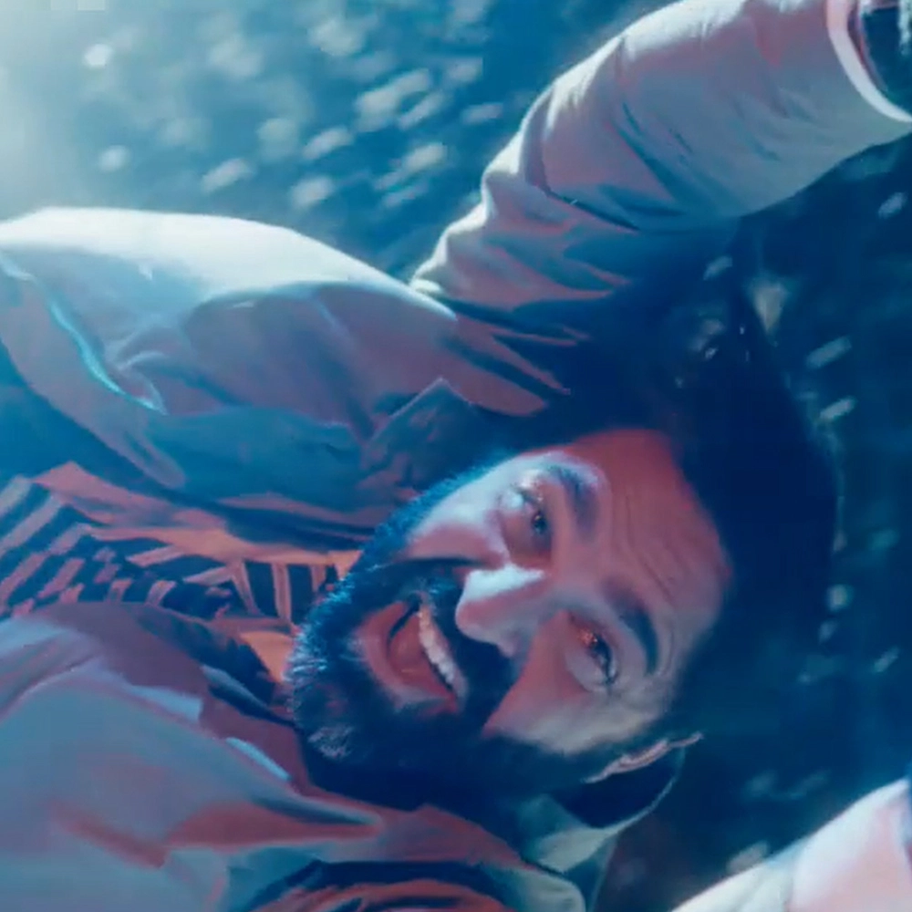 Man holding onto pole