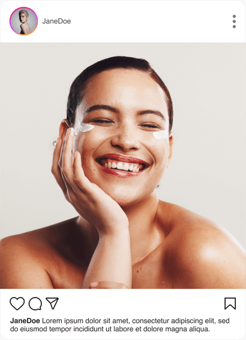 A woman smiling with a patch on her cheek.