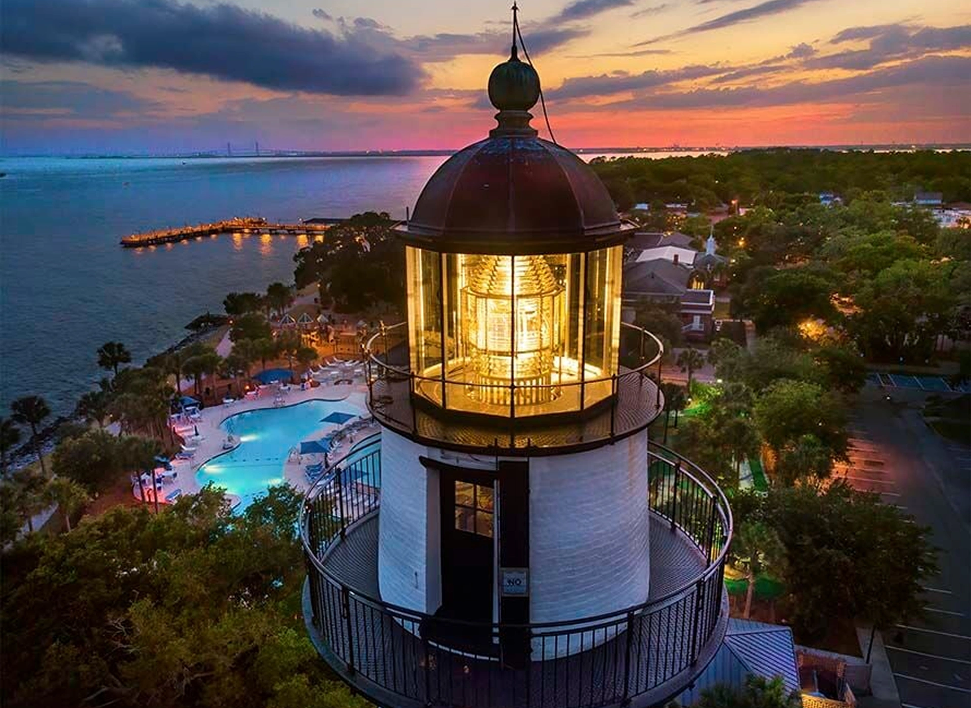 A lighthouse illuminated at dusk