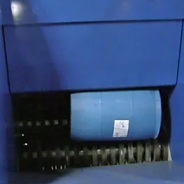 A blue machine with a blue barrel in it.