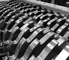 A row of metal plates sitting on top of a conveyor belt.