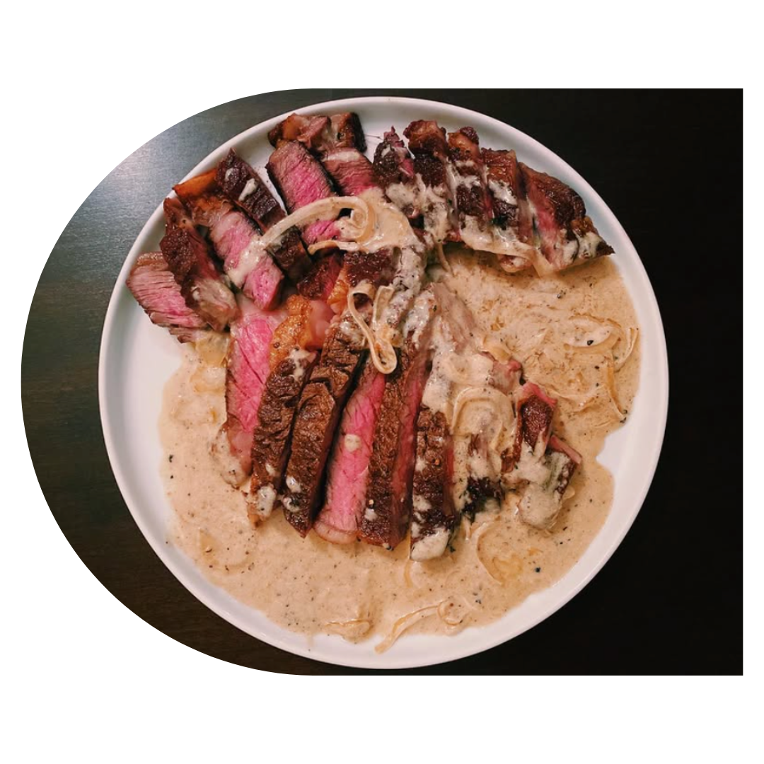 Positive young multiracial friends eating fast food and drinking beer in outdoor cafe