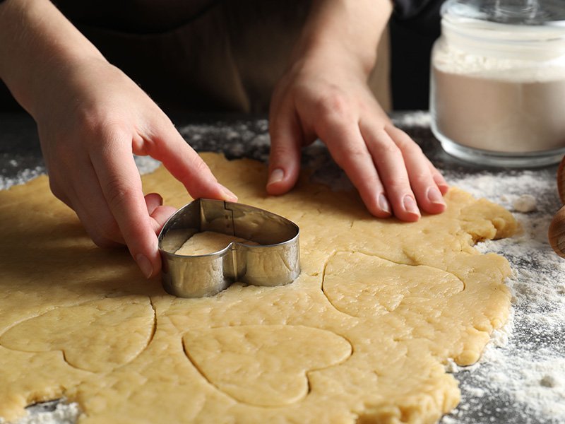 person baking sugar cookies