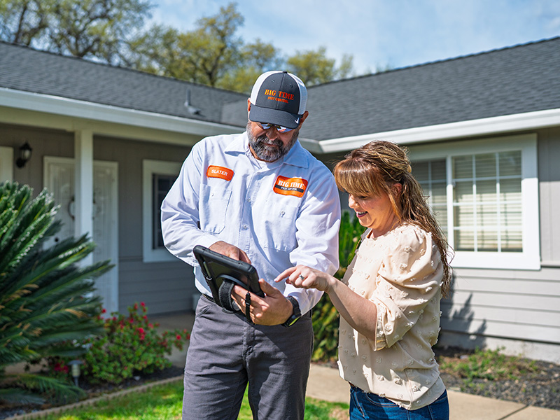 pest technician talking to homeowner