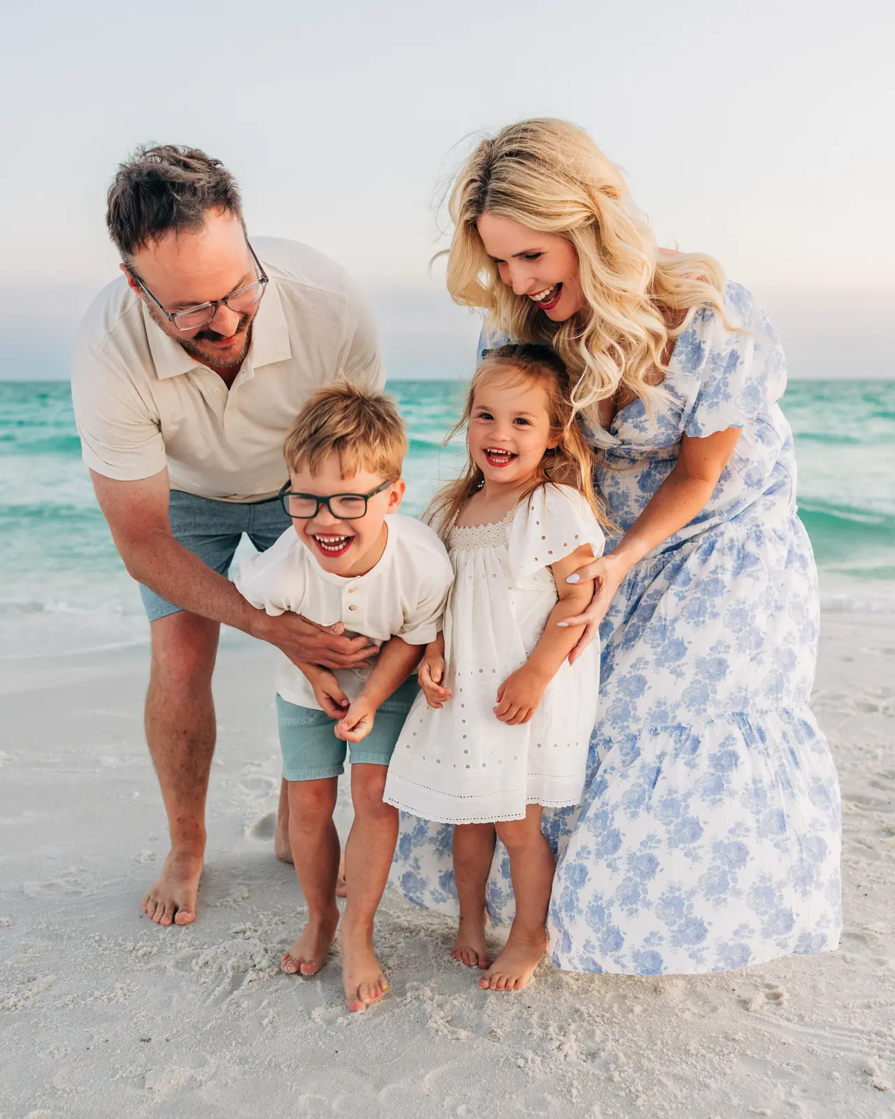 Family with young child walking on the beach in Blue Mountain Beach, Florida