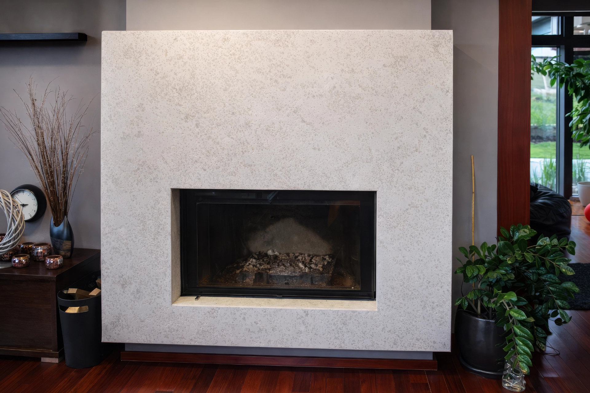 Minimalistický krb s velkoformátovým kamenným obkladem v pískovém odstínu, designová realizace z Hořic.