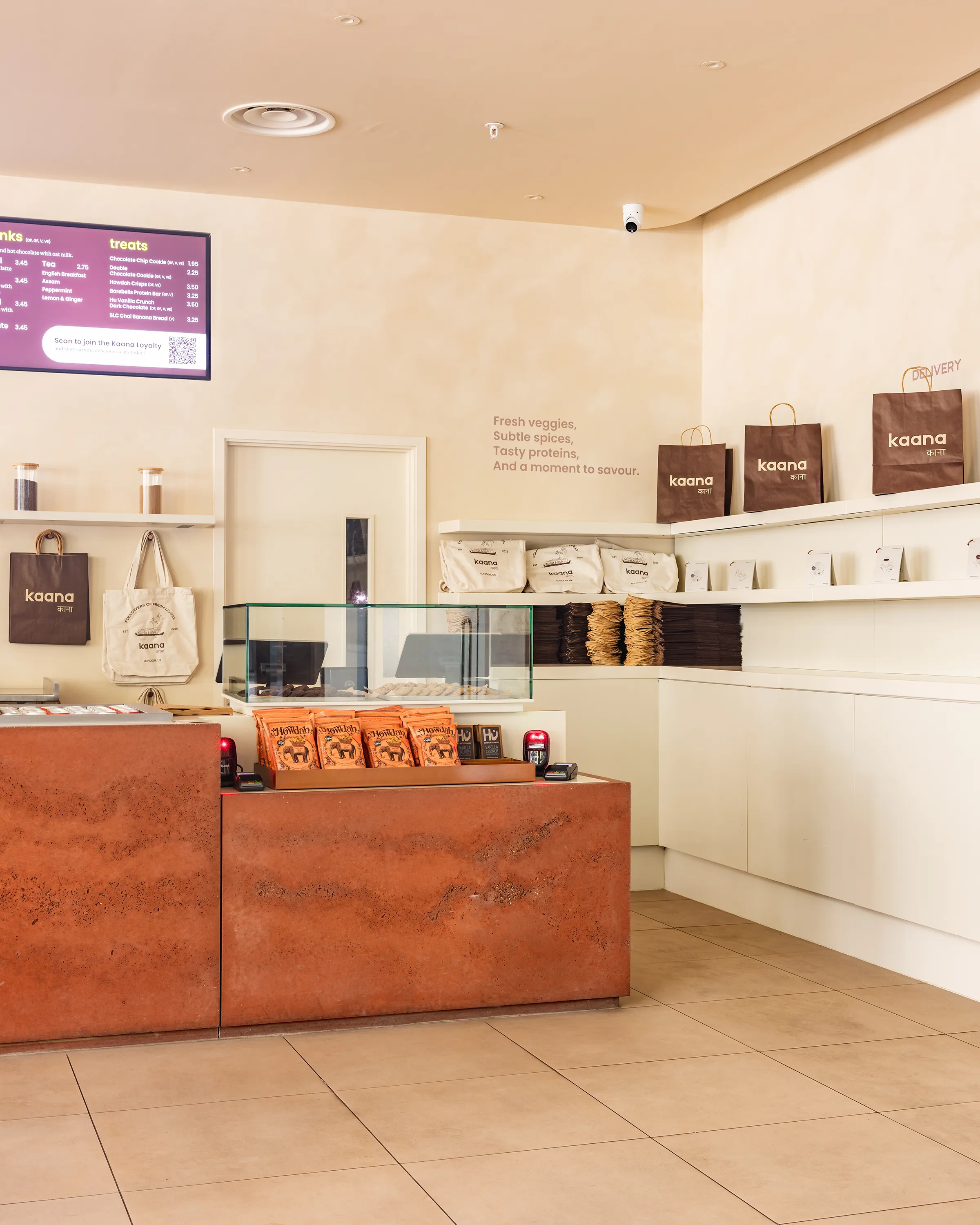 Kaana's counter with treats on display and shelves of branded bags