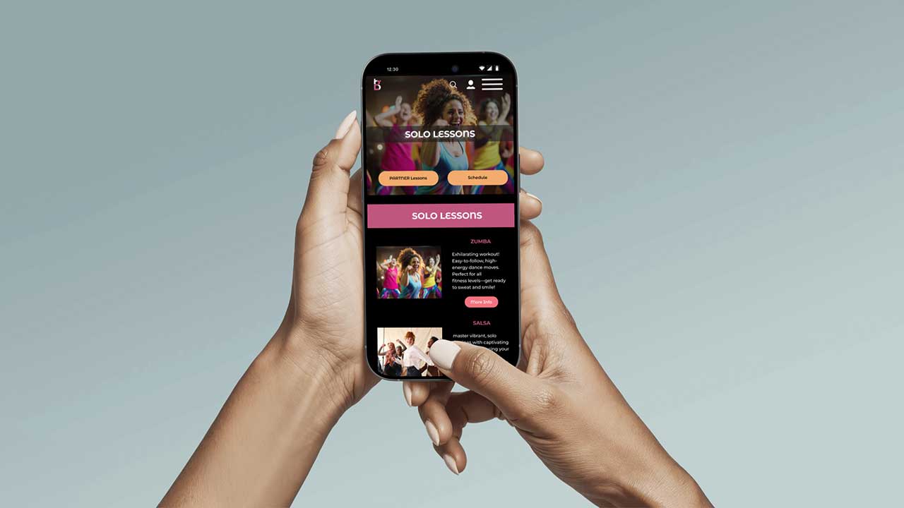 women hands holding cell phone with baza dance  website re-design page open