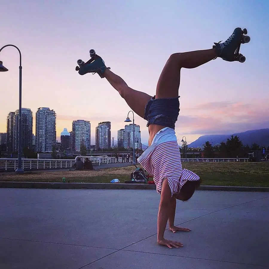 Sole Esnaola doing a hand-stand on roller skates in Vancouver, British Columbia