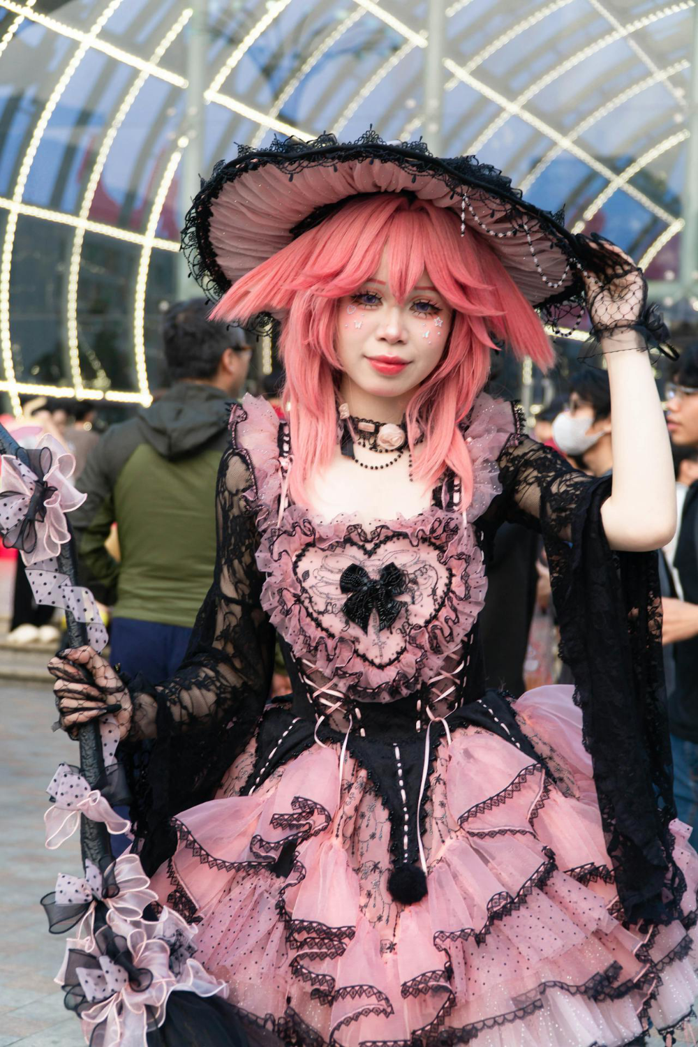 A young woman wearing an ornate pink and black steampunk costume