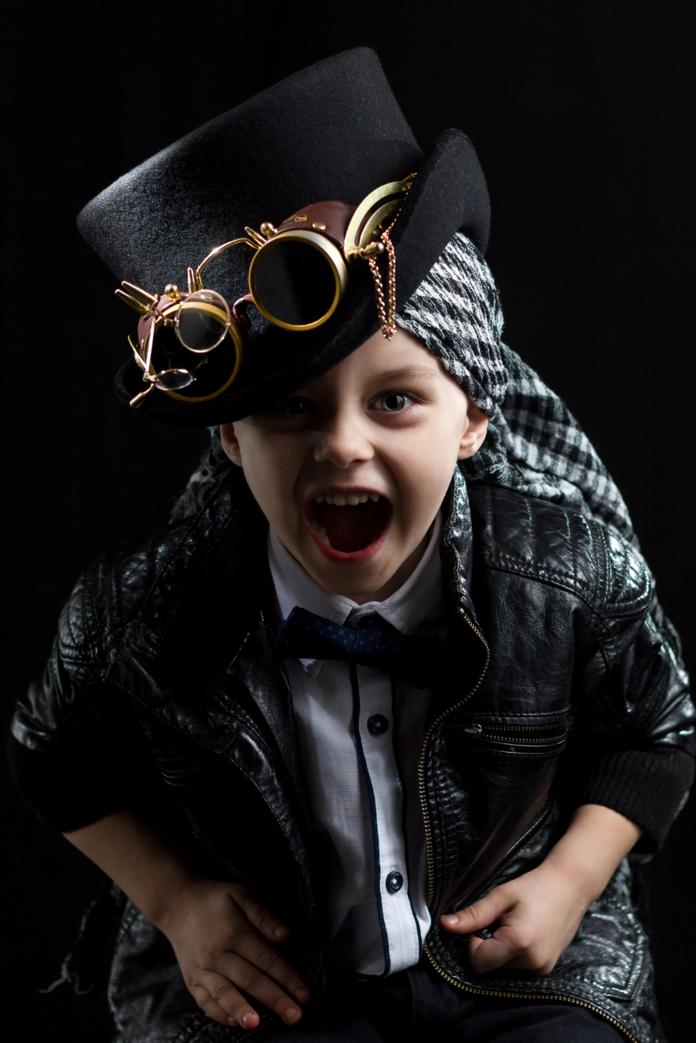 A boy wearing a black leather steampunk outfit