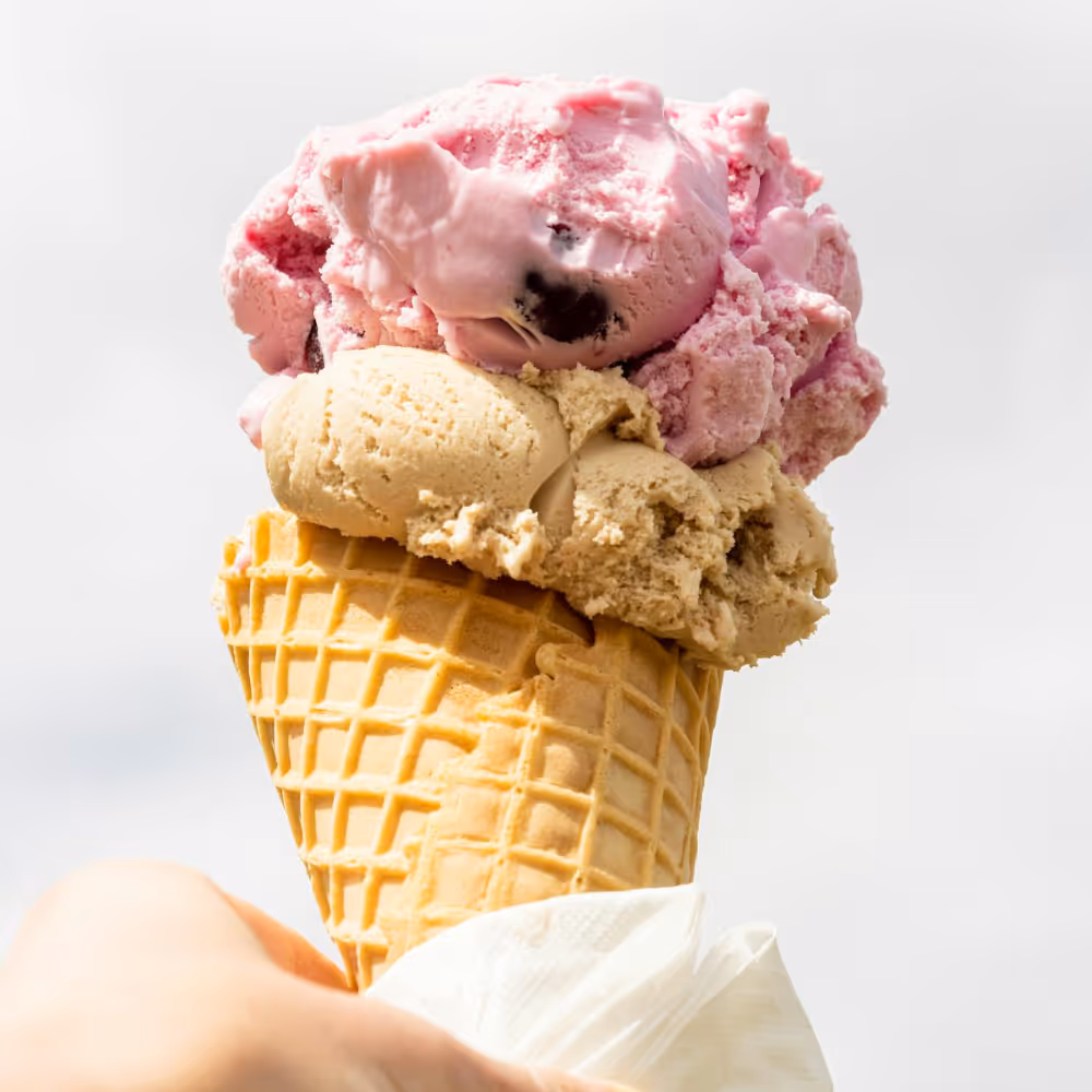 A cherry and butterscotch ice cream cone.