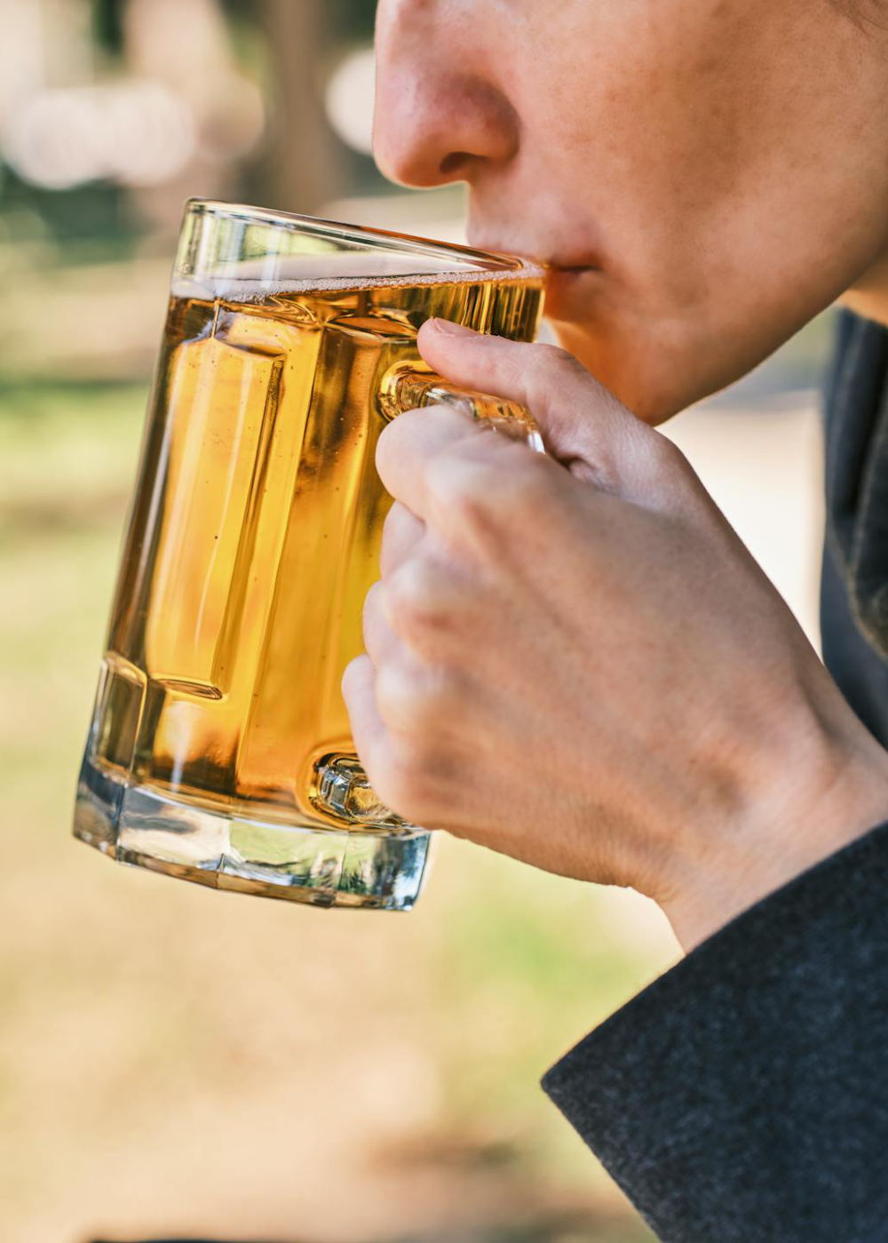 A woman drinking a glass of beer