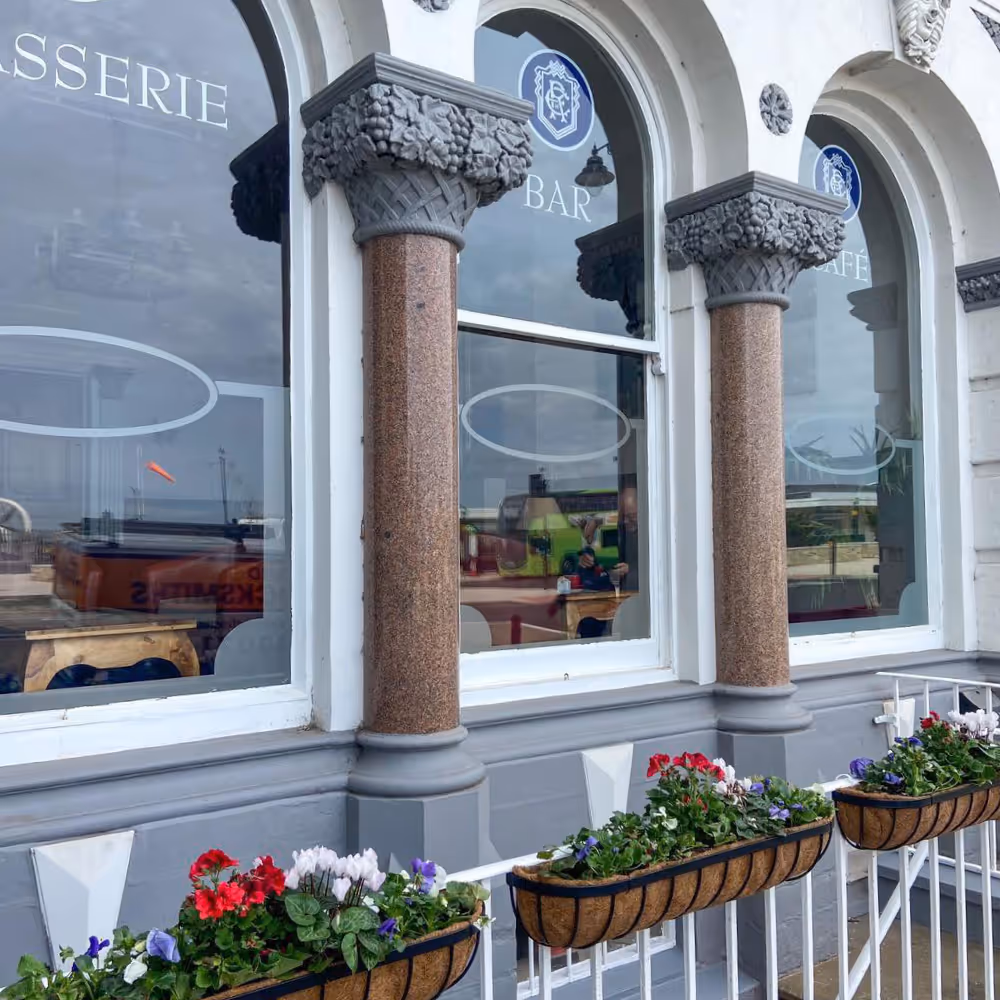 Exterior arched windows of a period Victorian hotel.