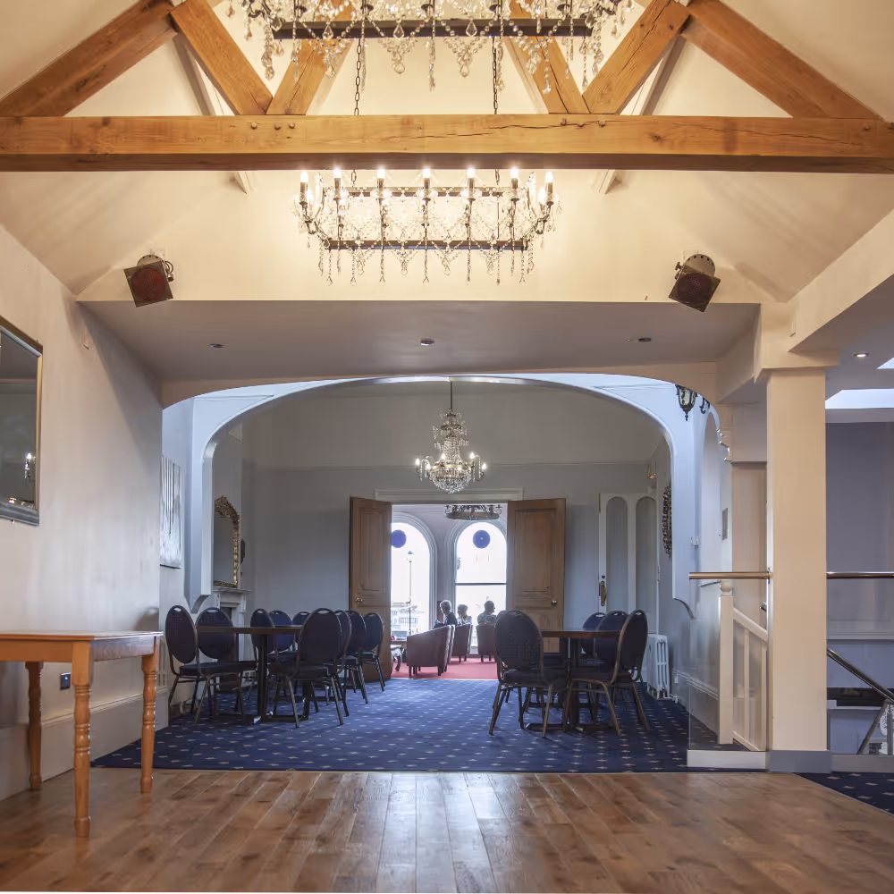 A hotel function room with wooden wooden beams.