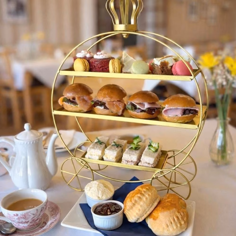 An afternoon tea consisting of sandwiches, scones, cake and tea.