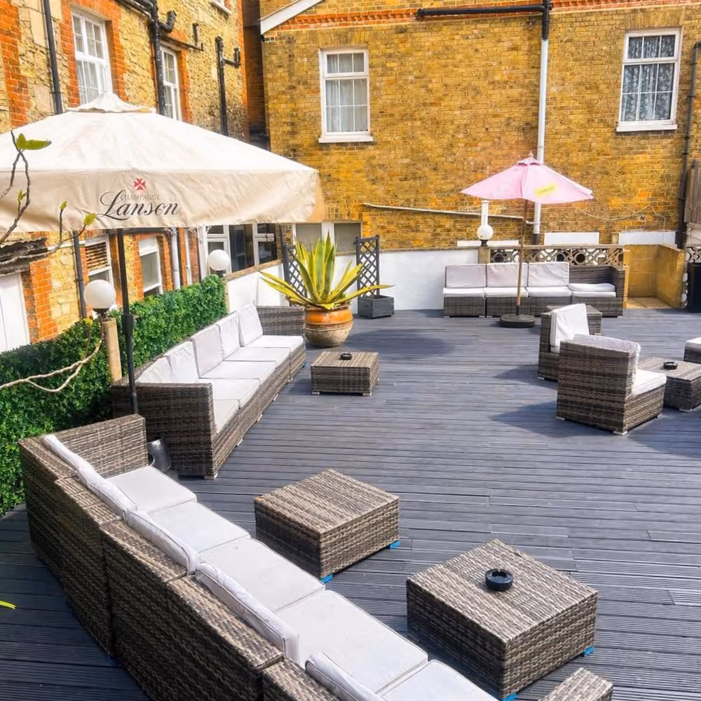 A decked courtyard garden of a hotel.