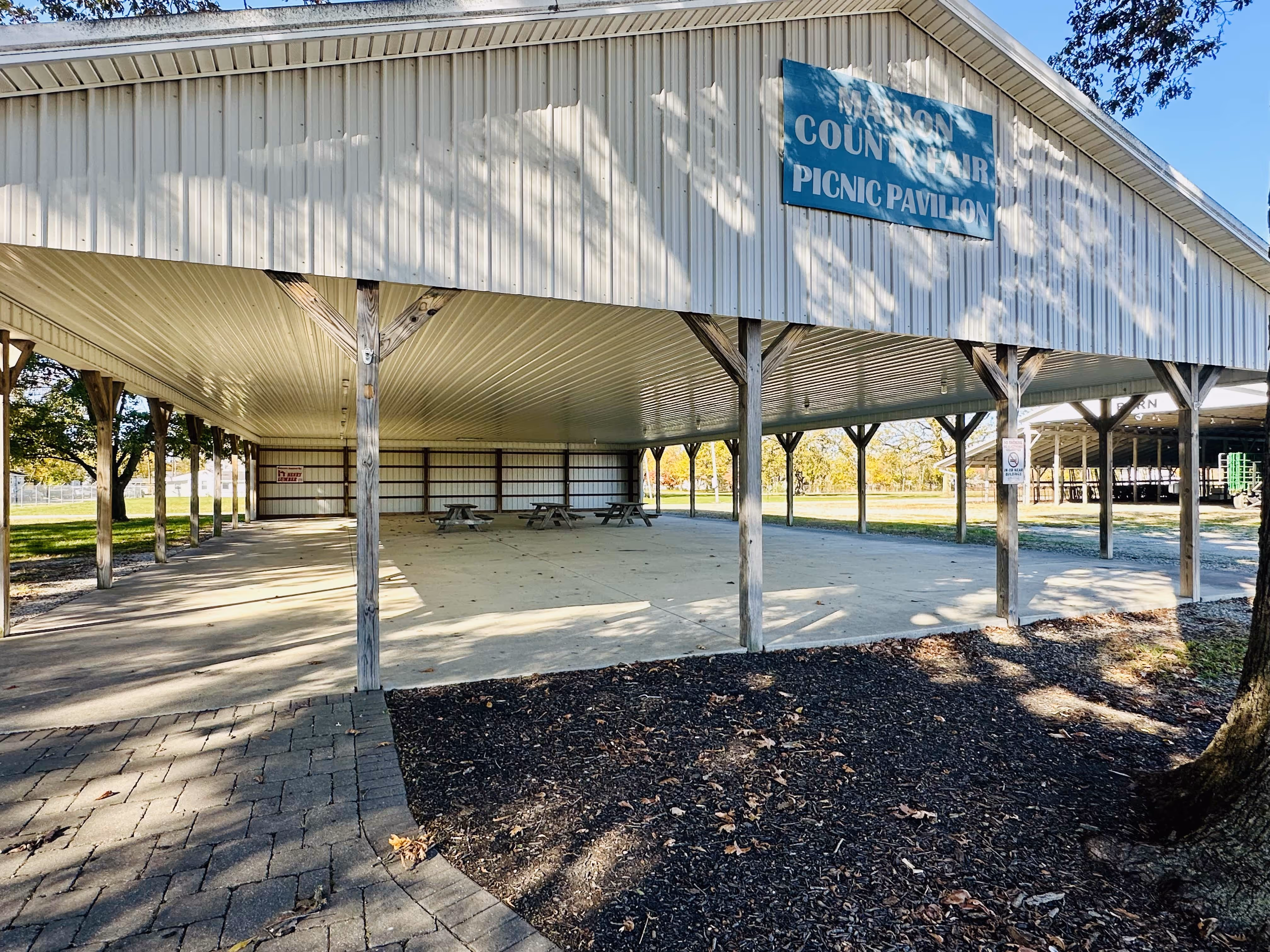 A large white building with a sign on the side of it.