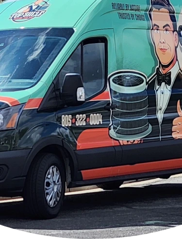 Teal and black van with tire service graphic and business phone number