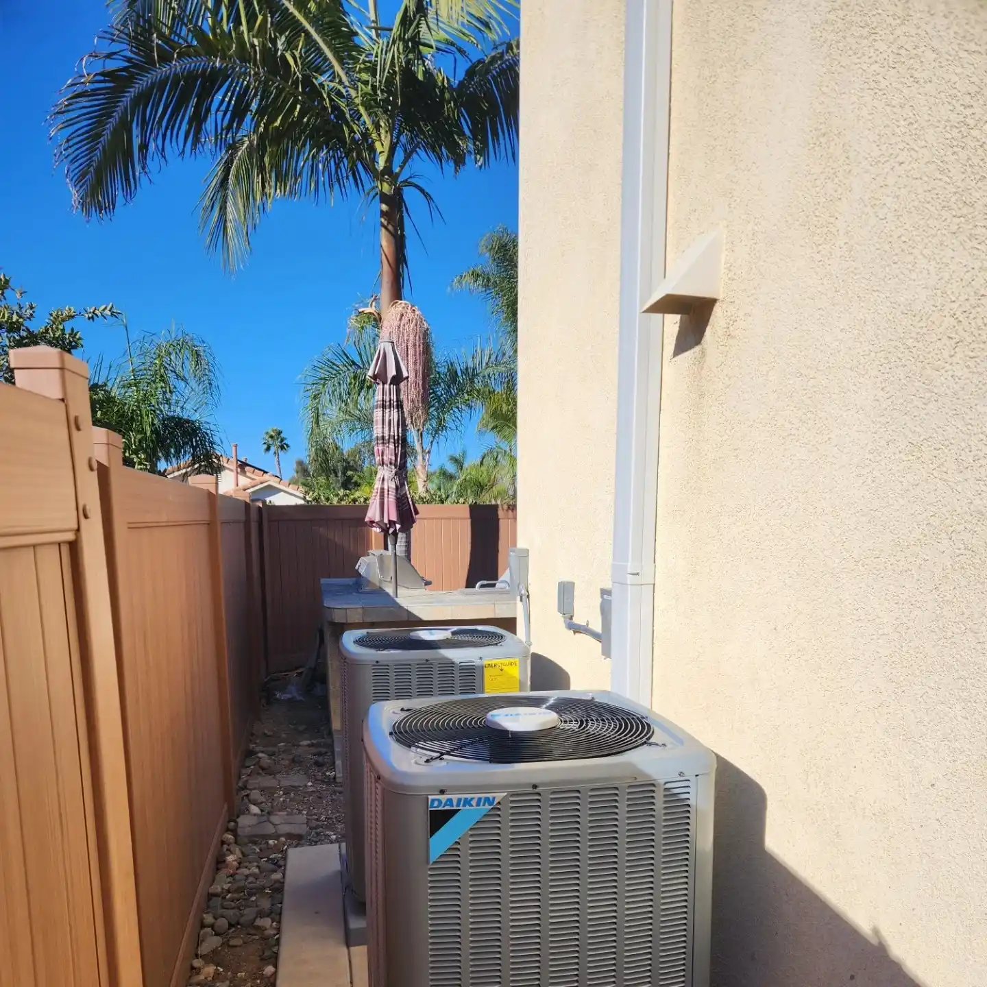 HVAC technician servicing a rooftop AC unit.