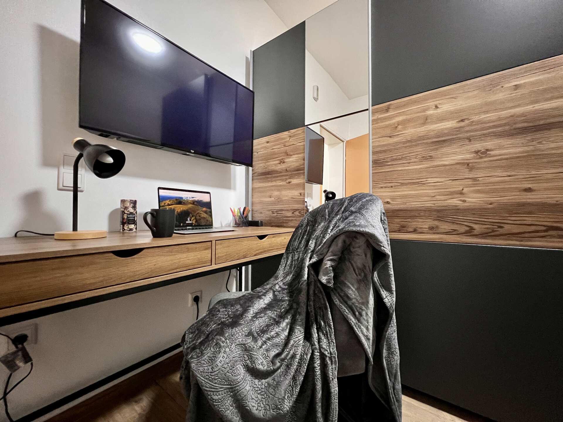 Arbeitsbereich mit Schreibtisch und Fernseher.