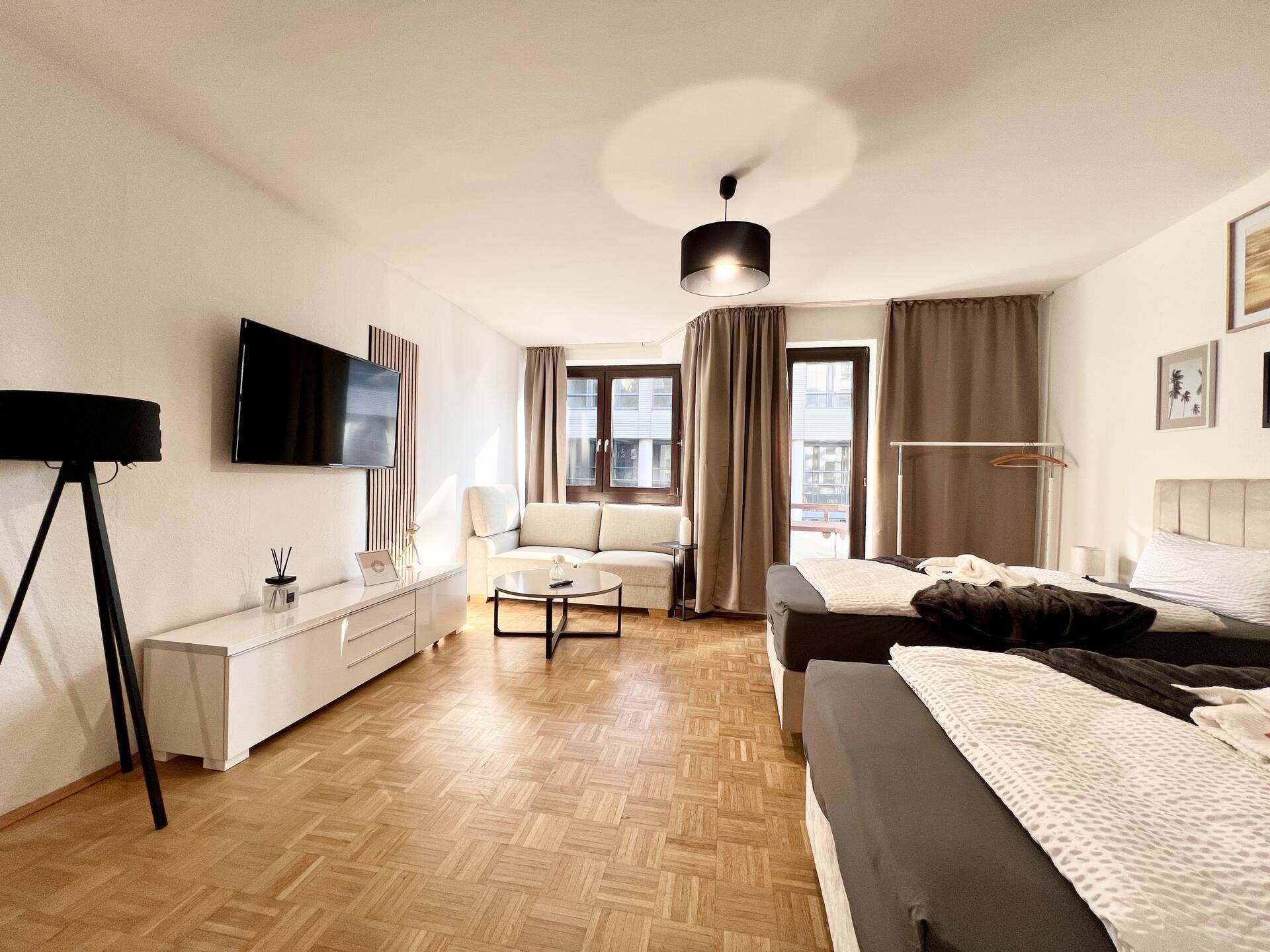 Schlafzimmer mit TV und großer Fensterfront