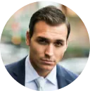 A man in a suit and tie looking at the camera.
