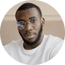 A man wearing glasses and a white shirt.