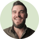 A man with a beard smiling in a circle.