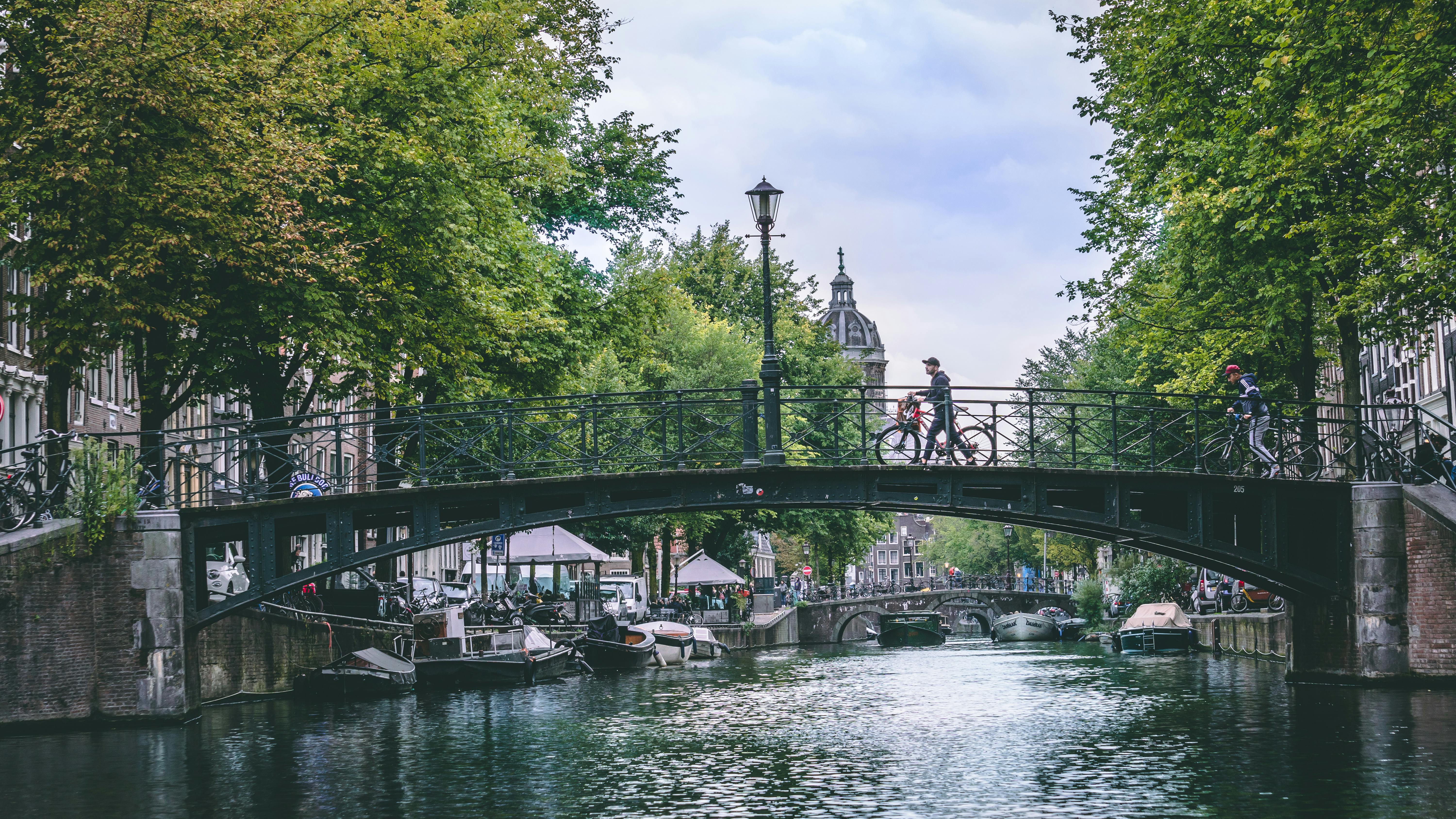 View of Amsterdam with canals, historic buildings, and bridges, host city of the AI & Big Data Expo Europe 2025.