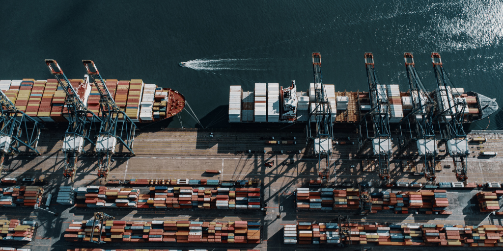 Maritime logistics hub with stacked shipping containers, used for analyzing operational risks in global trade.