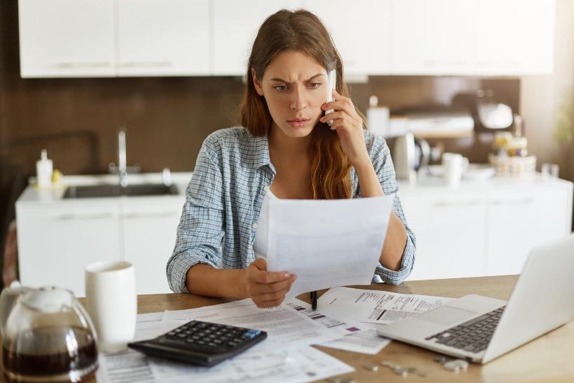 A person holding papers and talking on the phoneAI-generated content may be incorrect.