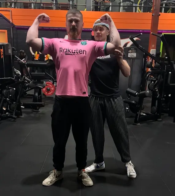 Dylan Barry helping a personal training client with his posing