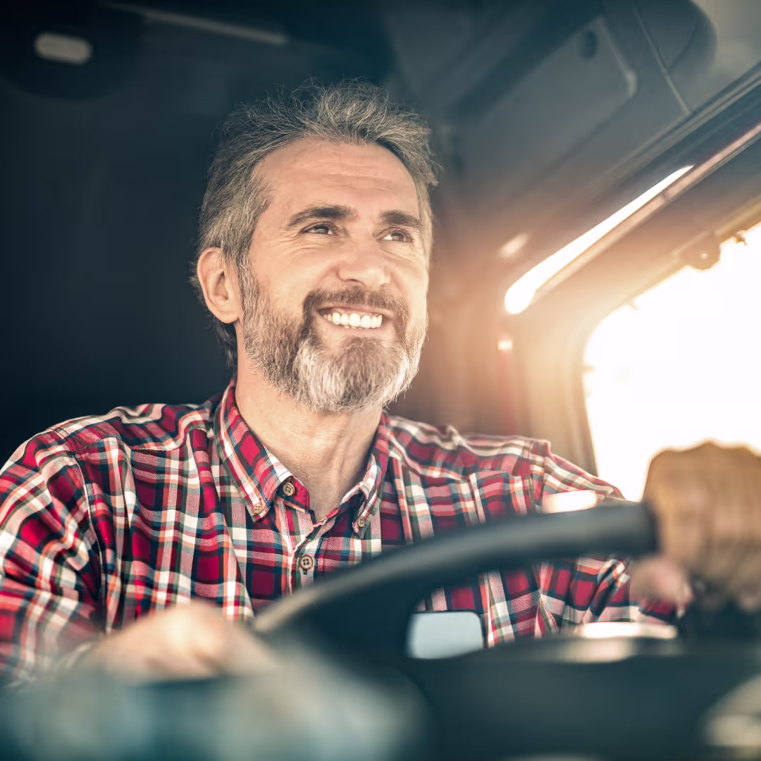 a man driving and smiling