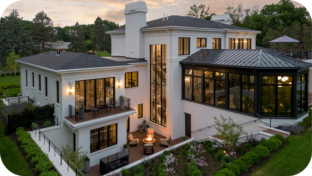 Luxury contemporary home with white exterior, expansive glass windows, balconies, and landscaped gardens creating a modern elegant design.