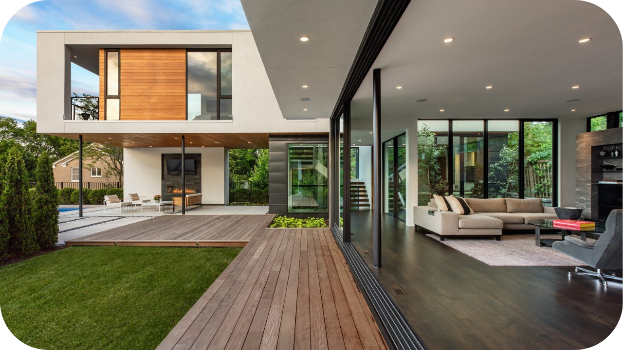 Contemporary luxury home with open-plan living, floor-to-ceiling glass walls, timber decking, and seamless indoor-outdoor design.