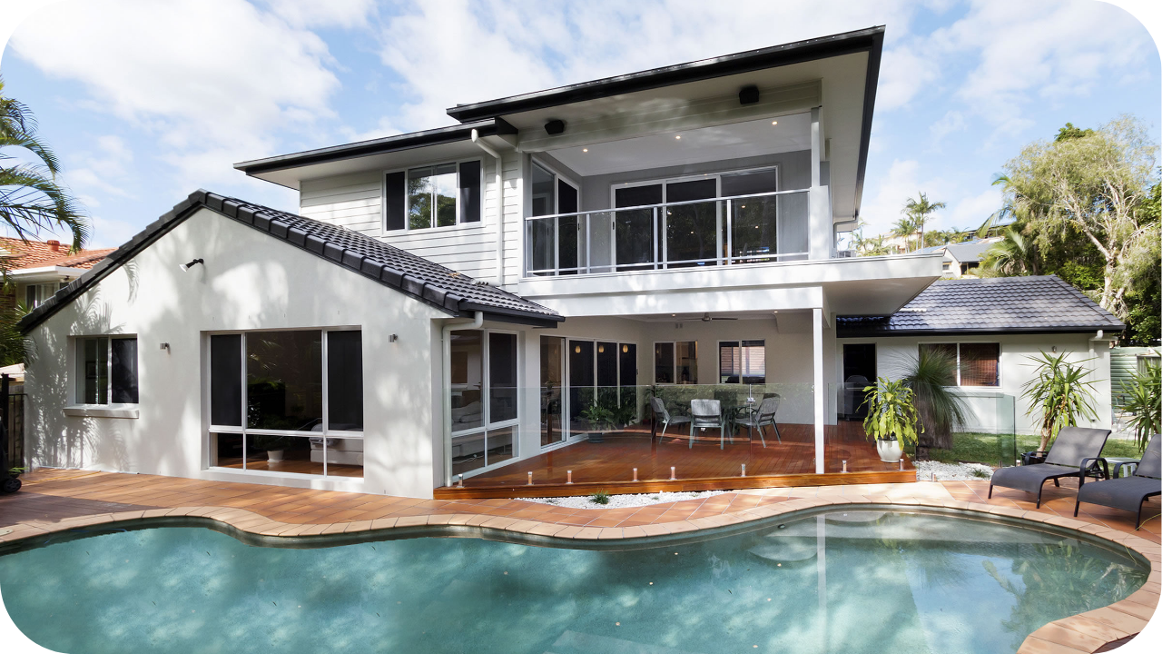 A contemporary double-storey Melbourne home with a modern ground-floor extension, glass doors, and a pool creating a seamless indoor-outdoor living space.