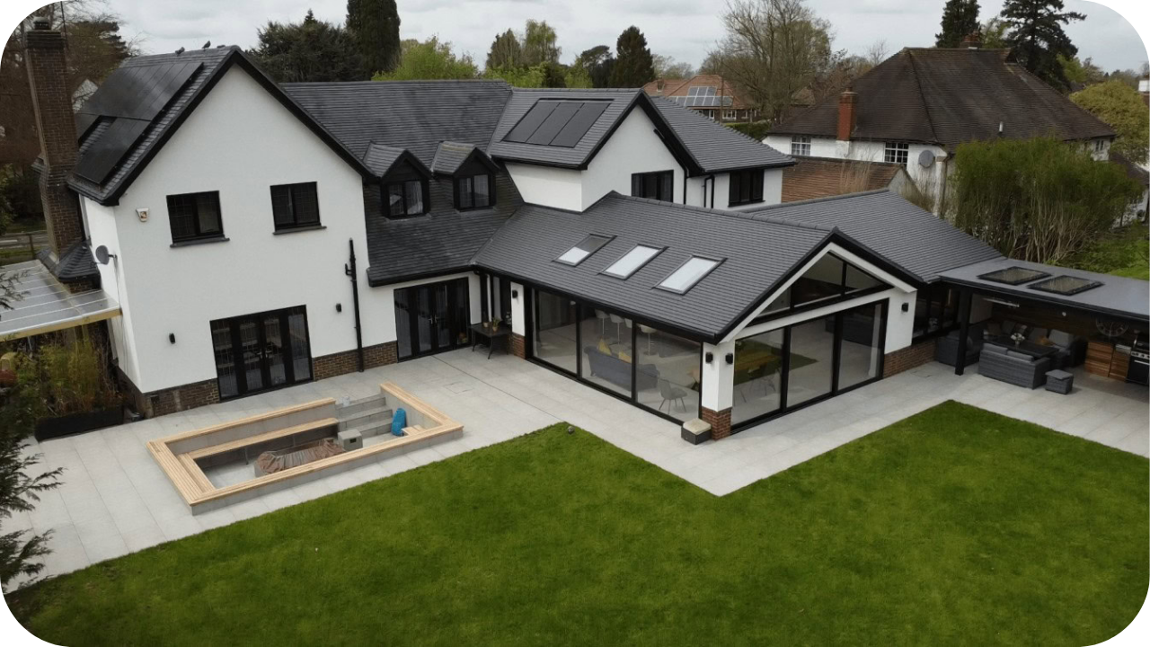 A spacious Melbourne home extension featuring solar panels, skylights, and modern architecture that blends sustainable design with elegant outdoor living areas.